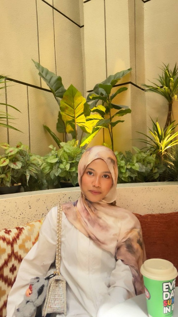 Naila sitting at a cafe